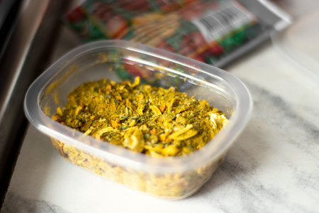 Spices for pilaf in a plastic container.