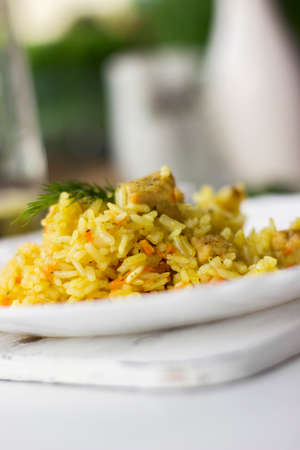Traditional pilaf, rice with meat, carrots and onions on a white background.の写真素材