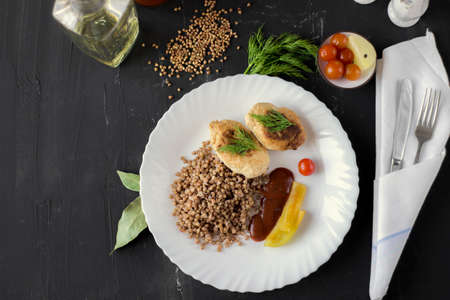 Chicken cutlets with buckwheat, herbs, ketchup and tomatoesの写真素材