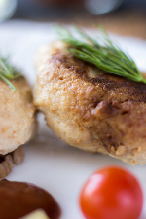 Chicken cutlets with buckwheat, herbs, ketchup and tomatoes