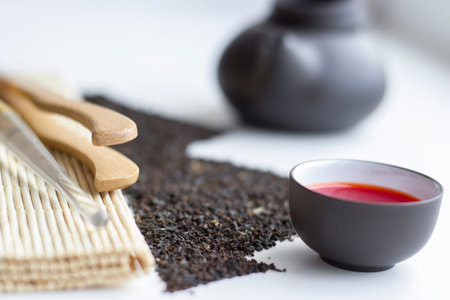 Oolong tea fresh red tea in a cup and black tea scattered in the shape of mountains