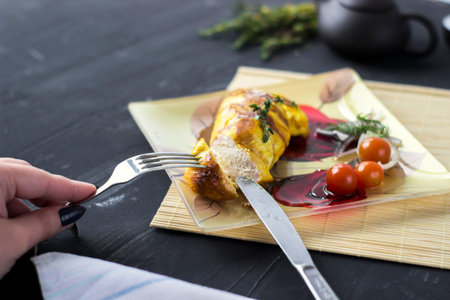 Baked chicken breast with onions and tomatoes on a white plate. Healthy food.