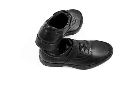 black childrenâs leather shoes with a white background, isolate .の写真素材
