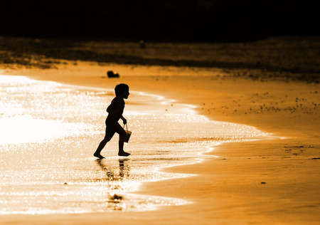 Child playing on the seashoreの写真素材