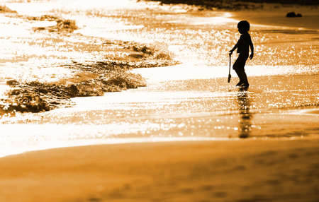 Child playing on the seashoreの写真素材