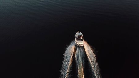 boat sailing in black waterの写真素材