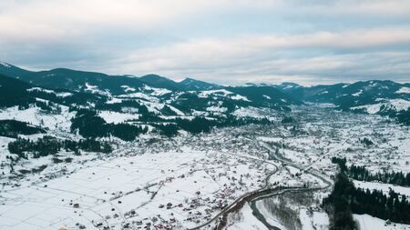 Beautiful landscape with mountain peaks covered with snow and cloudsの写真素材