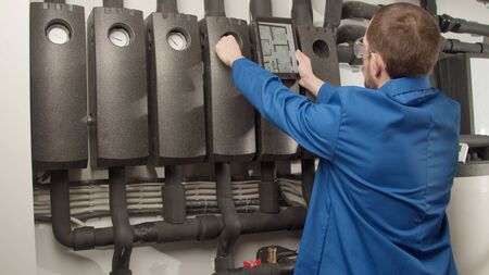 Young engineer checking new equipment with controllerの写真素材