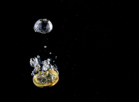 Sinking Euro. Splash of coins falling into the water. Coins in the water. Splash of coins falling...