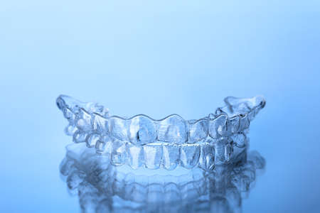 Invisible dental teeth bracket tooth aligners. Invisalign braces. Invisible aligner - Orthodontic temporary removable straighteners.の写真素材