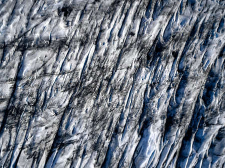 Aerial view of glacier from above, ice and ashes of the volcano texture landscape, beautiful nature ice background from Icelandの写真素材