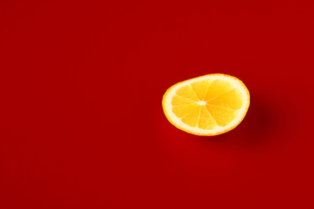 Bright yellow lemon on a red background.