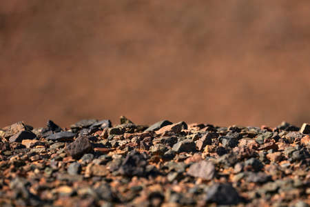 Black Gobi. Stony desert, black stones on the sand. Abstract natural background.の写真素材