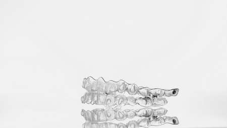 Invisible dental teeth bracket tooth aligners. Invisalign braces. Invisible aligner - Orthodontic temporary removable straighteners.の写真素材