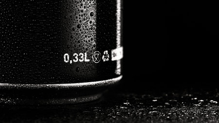 Black metal can 0.33L, with drops of condensation on the surface. Wet black alluminium can of beer,...