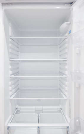 An empty refrigerator. Inside an empty, clean refrigerator, a refrigerator compartment after defrosting.の写真素材