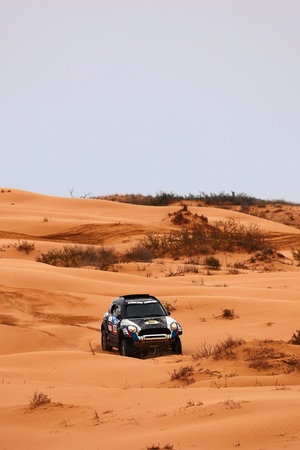Sports car gets over the difficult part of the route during the Rally raid THE GOLD OF KAGAN-2021. 04/26/2021 Astrakhan, Russia.のeditorial素材