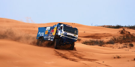 Sports truck KAMAZ gets over the difficult part of the route during the Rally raid in sand. THE GOLD OF KAGAN-2021. 04/26/2021 Astrakhan, Russia.のeditorial素材