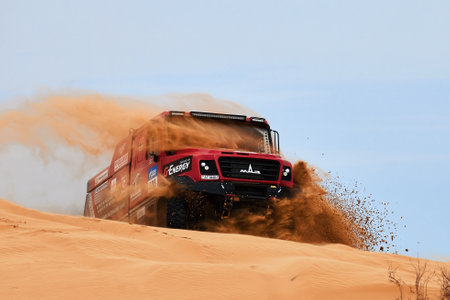 Sports truck MAZ Sport-auto team gets over the difficult part of the route during the Rally raid in sand. THE GOLD OF KAGAN-2021. 04/26/2021 Astrakhan, Russia.のeditorial素材