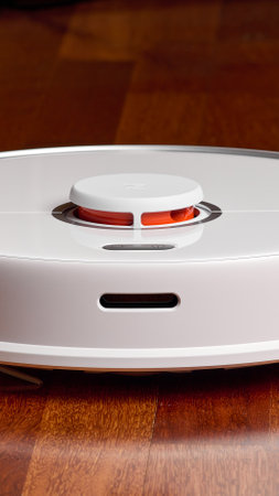 Smart Robot Vacuum Cleaner Xiaomi roborock s5 max on wood floor. Robot vacuum cleaner performs automatic cleaning of the apartment. 12/04/2020, Rostov region, Russia.のeditorial素材