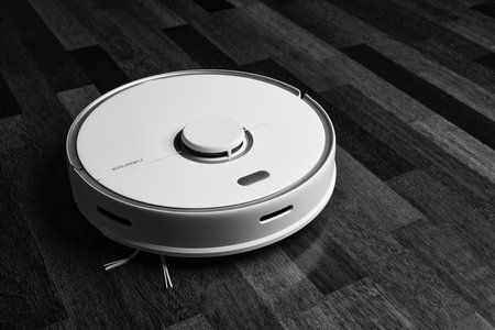 Smart Robot Vacuum Cleaner Xiaomi roborock s5 max on wood floor. Robot vacuum cleaner performs automatic cleaning of the apartment. 12/04/2020, Rostov region, Russia.のeditorial素材