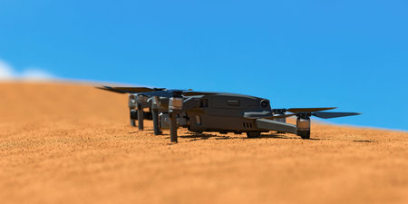 Quadrocopters are built on the sand in the desert waiting for takeoff.のeditorial素材