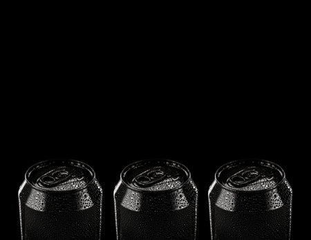 Black metal can. black alluminium can of beer, lemonade or tonic isolated on black background. Empty packaging mockup with no label.の写真素材