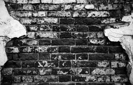 Old Brick Wall with plaster remnants, Brick wall background texture.の写真素材