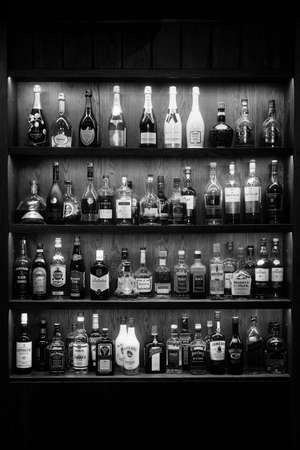 Bottles With Alcoholic in a bar. Bottles of alcoholic beverages are on the shelves. Bar on the wall. 06.06.2021, Rostov region, Russiaのeditorial素材