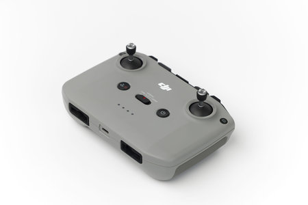 DJI remote control on white background. Control stick of the DJI Mavic 3 drone. Unpacking and...