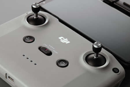 DJI remote control. Control stick of the DJI Mavic 3 drone remote control with mobile phone attached. Unpacking and configuring the DJI copter. 17.12.2021, Rostov region, Russiaのeditorial素材