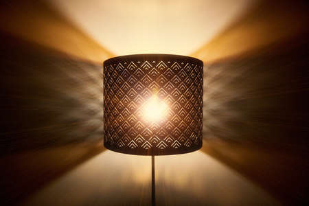 Floor lamp light. Rays of light through the holes in the lamp floor lamp. Bright shining lamp in the nightの写真素材
