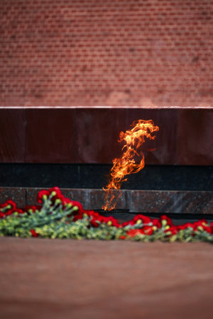 Flowers by the Eternal Flame. Eternal Flame in the Kremlin. Guard of Honor at the tomb of the Unknown Soldier at the wall of Moscow Kremlin. 05/11/2022 Moscow, Russia.のeditorial素材