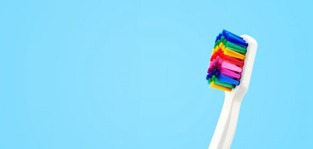 White toothbrush with multicolored bristles. Bristles in all colors of the rainbow. Rainbow toothbrush with white knob. Fashionable oral care.の写真素材