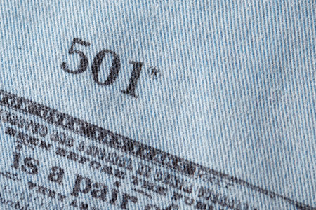 Close up of the details of new LEVIS 501 Jeans on the inside. label and stamp LEVIS. Classic jeans model Levi Strauss on the underside of the textile. 31.12.2021, Rostov, Russiaのeditorial素材