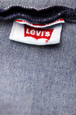 Close up of the of the label of new LEVIS 501 Jeans on the inside. Logo and stamp LEVIS on the underside of the textile. Classic jeans model Levi Strauss. 31.12.2021, Rostov, Russiaのeditorial素材