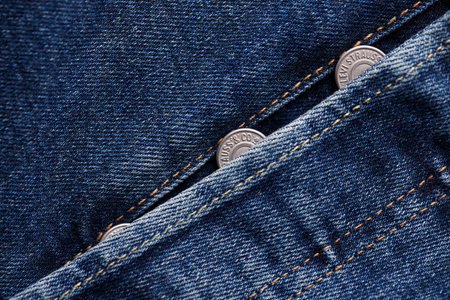 Close up of the details of new LEVIS 501 Jeans. Seams and button fly close-up. Classic jeans model. LEVIS is a brand name of Levi Strauss and Co, founded in 1853. 31.12.2021, Rostov, Russiaのeditorial素材