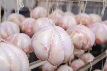 Chicken. The line for the production of smoked delicacies. Industrial manufacture of sausage products. Smokehouse of meat products.の写真素材