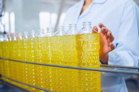 Line for the production of sunflower and olive oil. Bottles with oil close-up.