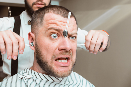 Waxing. Hair removal in the ears. Pulling hair from ears.の写真素材