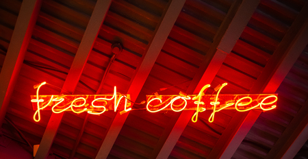 Red neon sign fresh coffee. Abstract hipster background.の写真素材