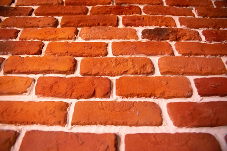 Weathered texture of stained old dark brown and red brick wall background, grungy rusty blocks of stone-work technology, colorful horizontal architecture.の写真素材