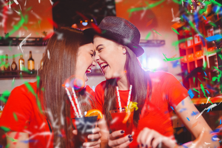 Confetti party. Two young girls lesbians at a party in the club.の写真素材