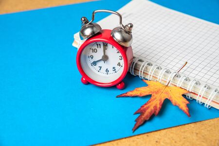 Back to school concept. Alarm clock and school supplies. Copy space.の写真素材