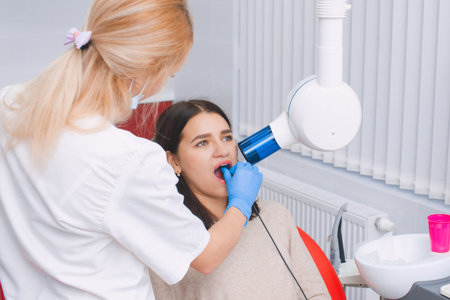 Tooth x-ray in the dental office. Young girl at the dentist's appointment.