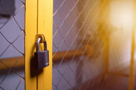 Closed padlock on the gate side view. copyspaceの写真素材