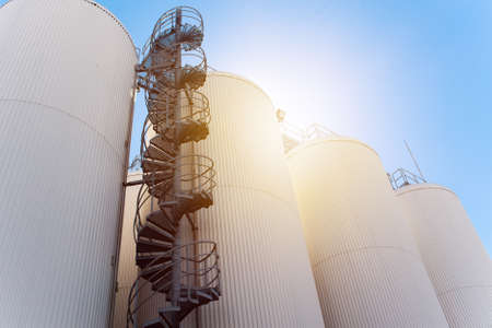 Rows of brewing tanks against the sky. Industrial beer productionの写真素材