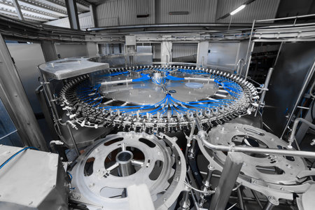 Automatic filling line for carbonated mineral water and beer. Isobaric filling. Industrial beer...