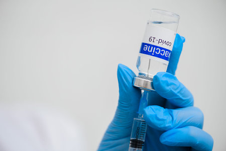 vaccination. vaccine and syringe in doctor s hands closeup