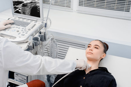Doctor in diagnostic center making ultrasound thyroid gland test. Ultrasound of thyroid gland